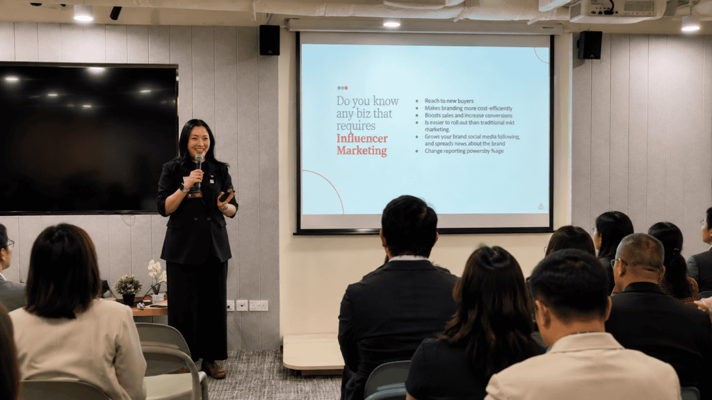 TMR Media founder Jusmin Tan presenting her entrepreneurial journey and digital marketing insights during a BNI Singapore networking session.