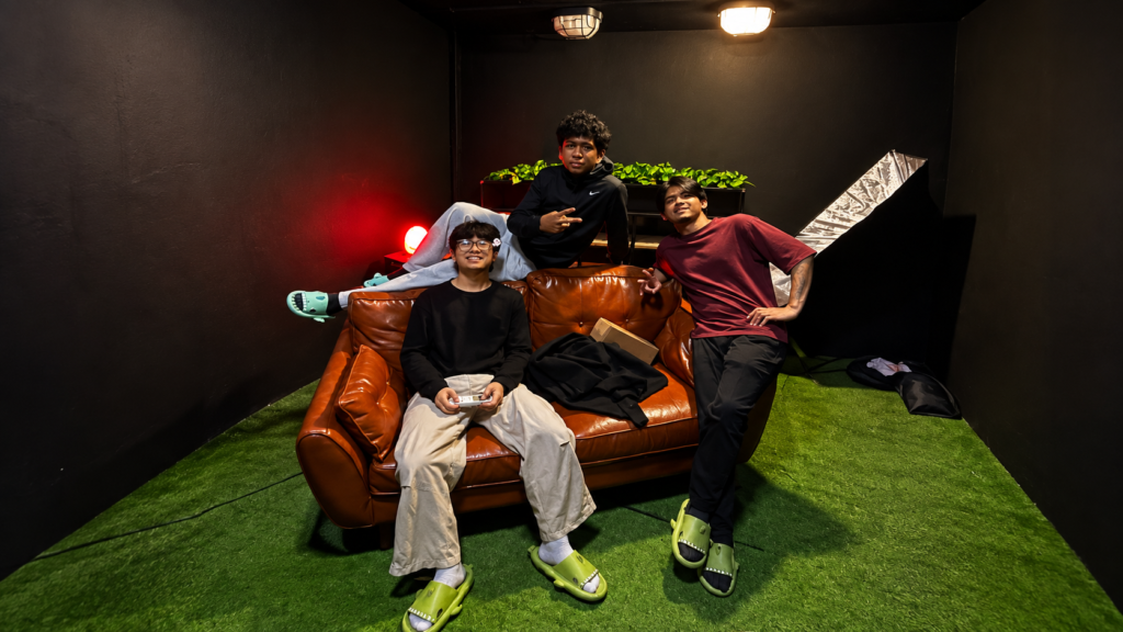 Three members of the TMR Media production team relaxing on a studio set between content shoots